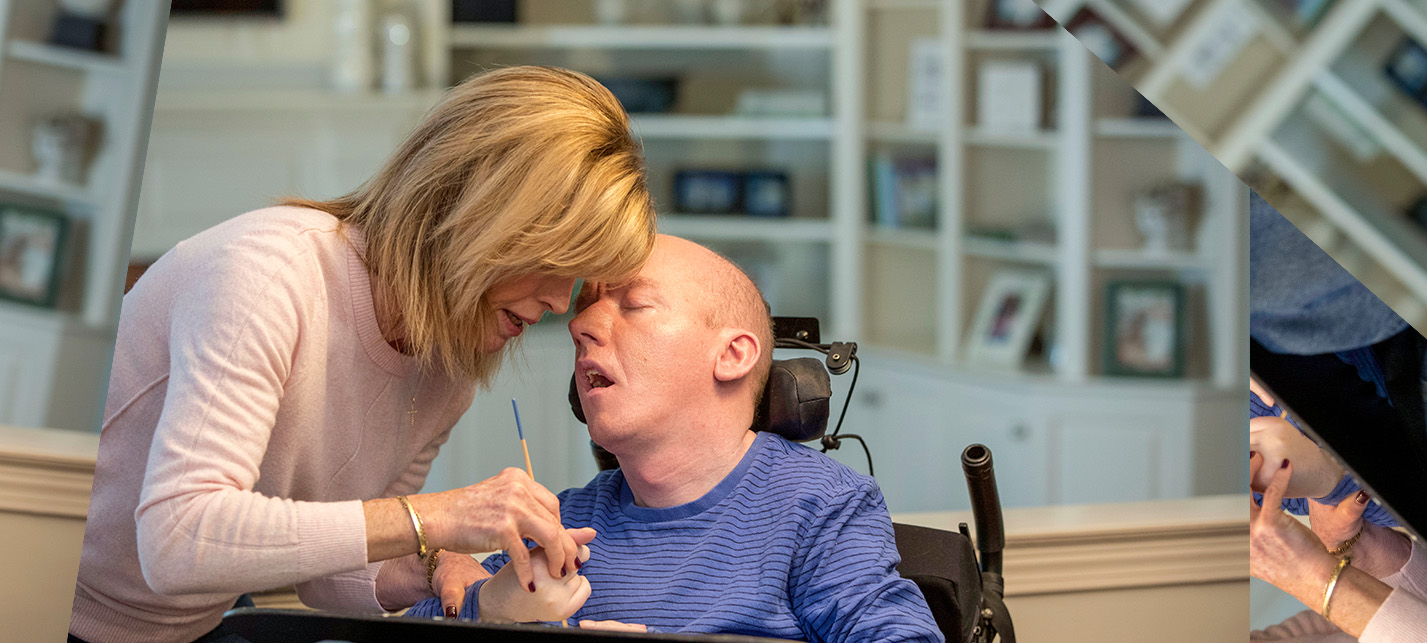 Mother leaning down touching foreheads with her son with CALD