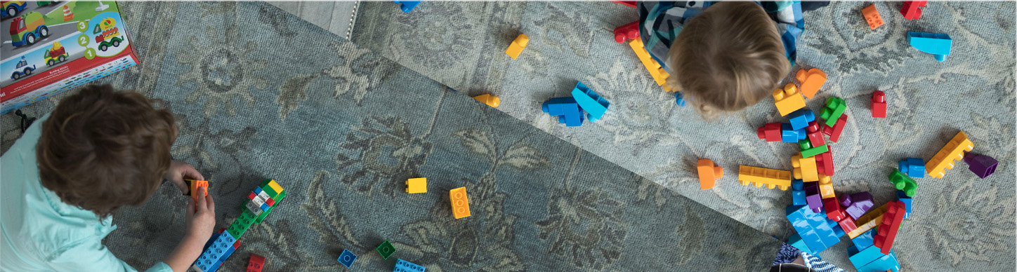 Young boy playing with brightly colored building blocks